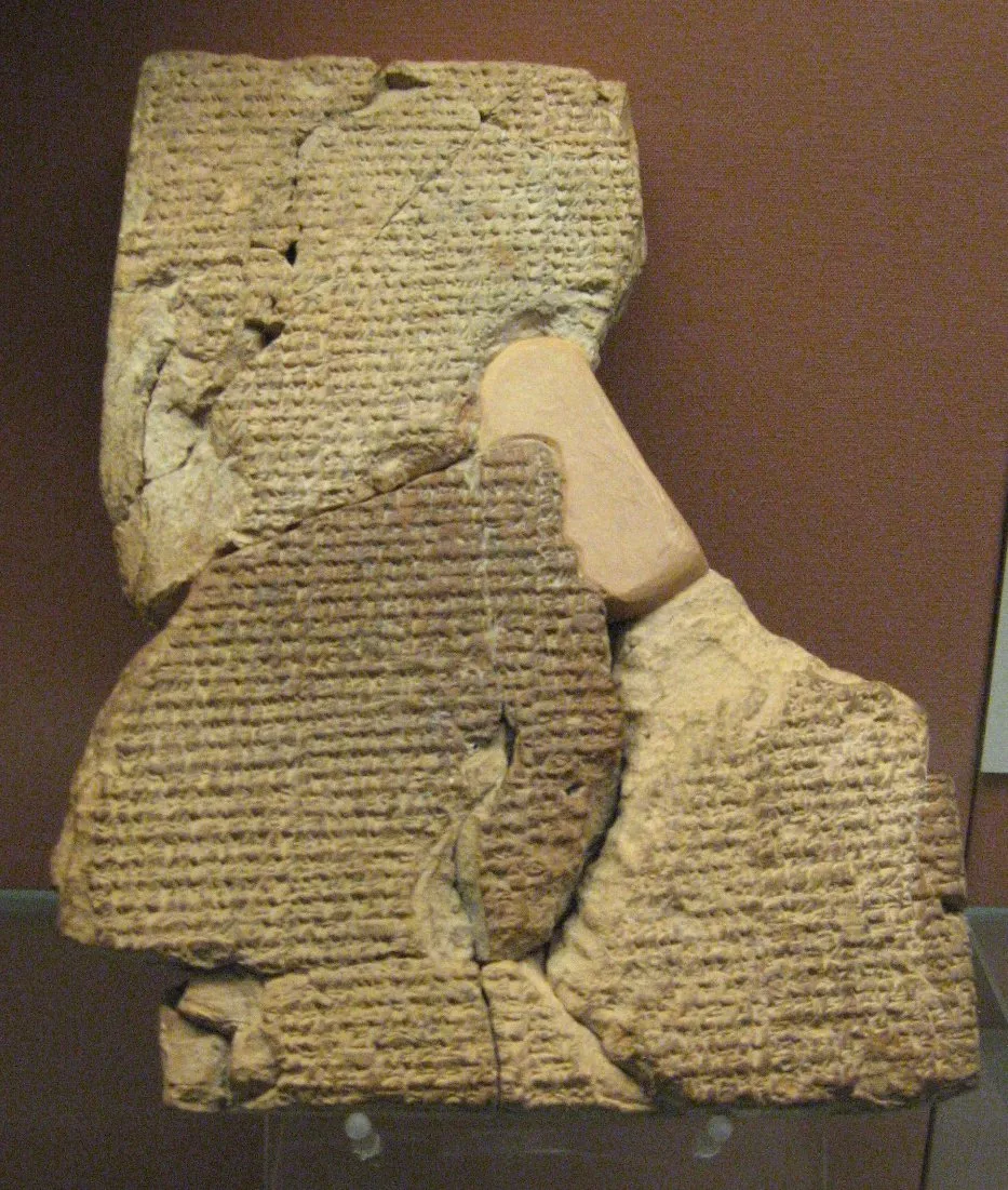 Atrahasis tablet: a broken clay tablet from Sippar with rows of cuneiform, shown against a red museum wall