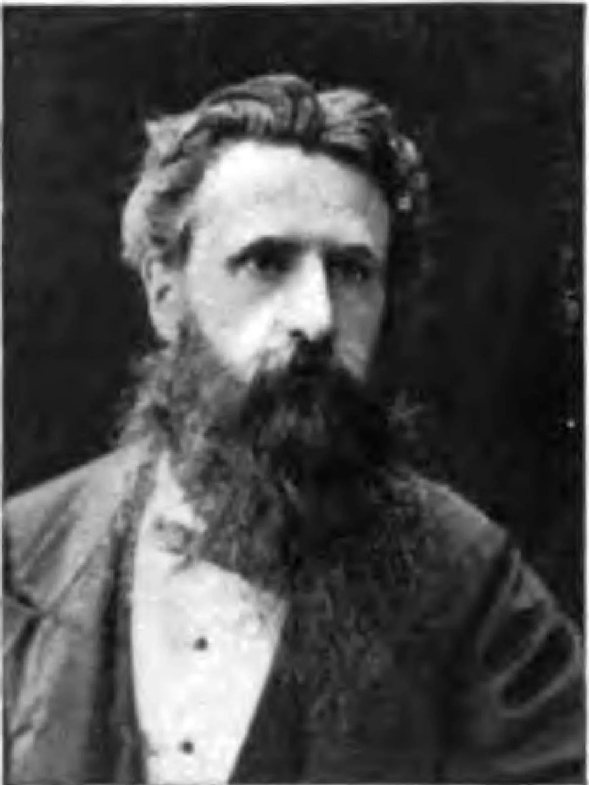 Black-and-white portrait of the Assyriologist George Smith, bearded, in a dark jacket and white shirt
